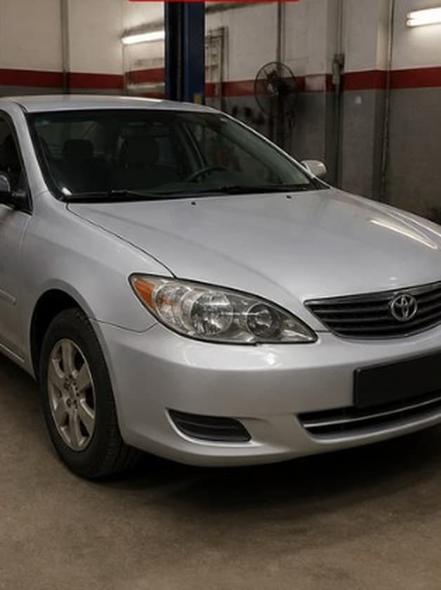 Silver sedan with a front corner dent and bumper damage, after repair